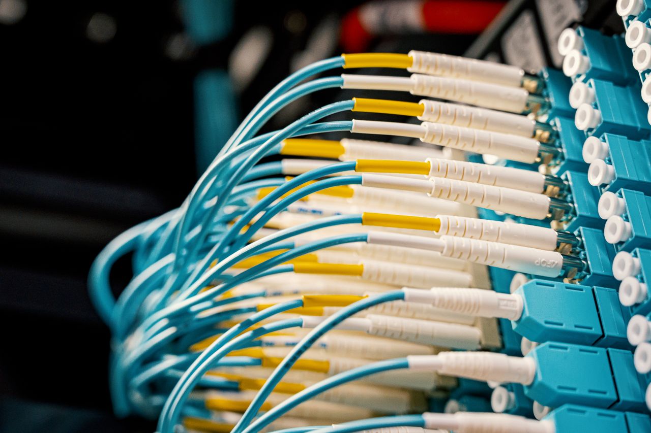 Mastering the First Impression: Your intriguing post title goes here High angle of fiber optical switch with connected cables in modern server room