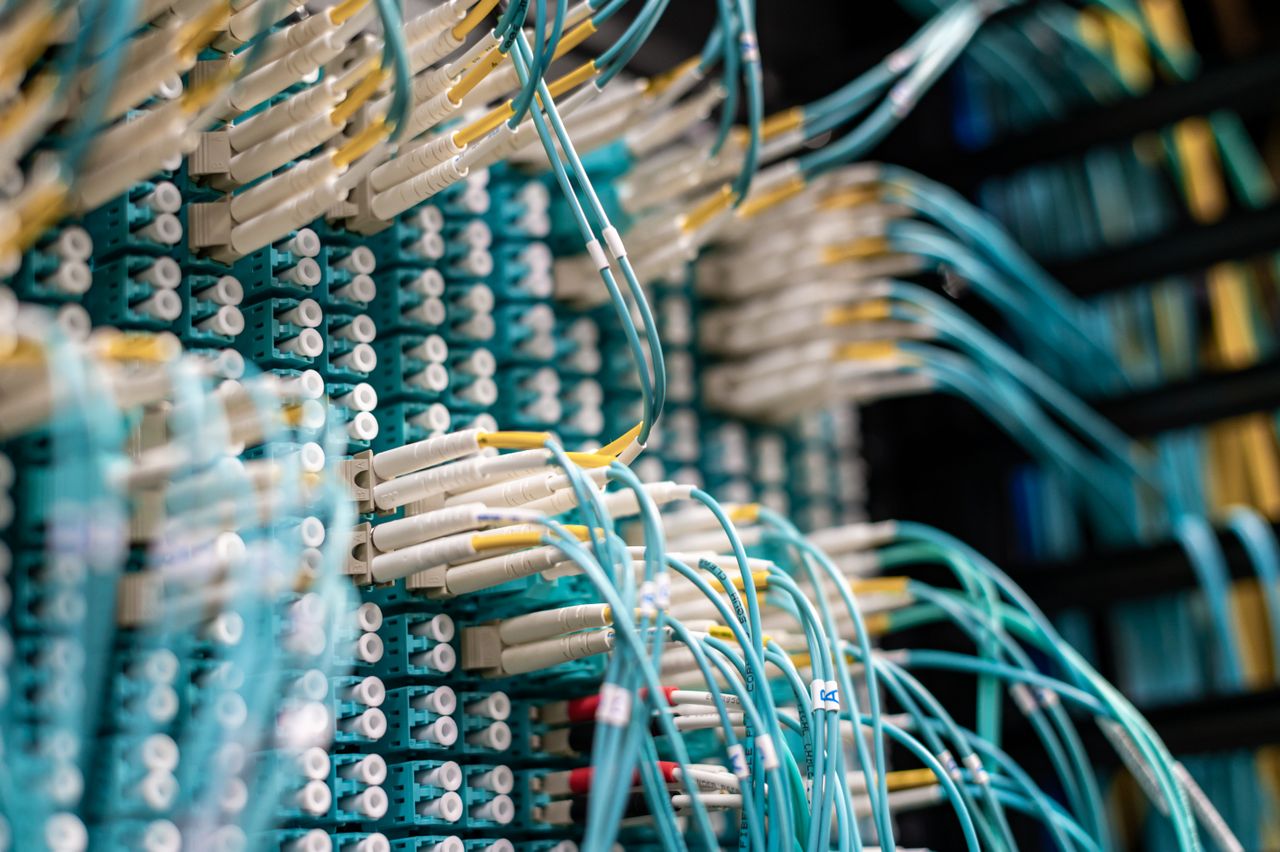 Crafting Captivating Headlines: Your awesome post title goes here From below of long thin blue cables connected to row of small white connectors on system block in data center
